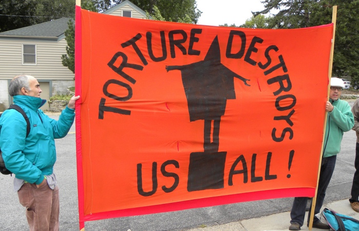 Activists hold a banner image with the outline of a detainee in the notorious Abu Ghraib prison in Iraq with the words "Torture destroys us all" underneath. Extrajudicial rendition to torture has been practiced by Canada and is among the most disturbing violations of civil liberties under the disastrous "war on terror."