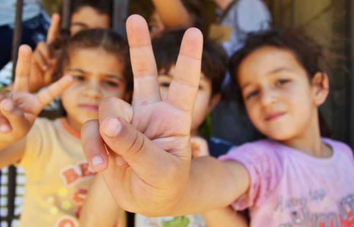 Syrian refugee children at a half-built apartment block near Reyfoun in Lebanon. Photo CC-BY Trocaire