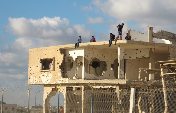 Children play on top of a shell of a building destroyed by Israeli military fire in Gaza