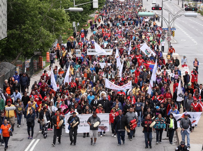 A large group of people marches in the streets of Ottawa as part of the closing ceremonies of the Truth and Reconciliation Commission of Canada