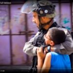 An Israeli soldier walks with his arms around the shoulders and neck area of a struggling Palestinian boy - screenshot from the short documentary Detaining Dreams.