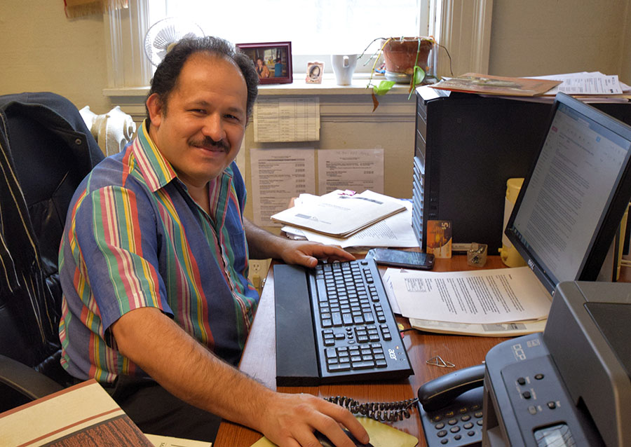 Picture of Eusebio Garcia in his office at Toronto Friends House (Quakers). Eusebio provides free service to refugees and newcomers who are already in Toronto