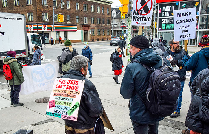 Protesters in Toronto call for investment in the wellbeing of Canadians instead of the purchase of new F35 fighter jets.