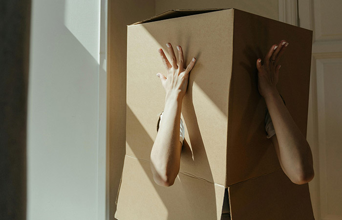 People aren't in fixed boxes, research shows we change all the time. A photo shows a person stands with a box over their head and their arms coming out of holes in it.