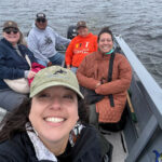 People in a small boat out on the water during Canadian Friends Service Committee's staff visit to Eeyou Istchee
