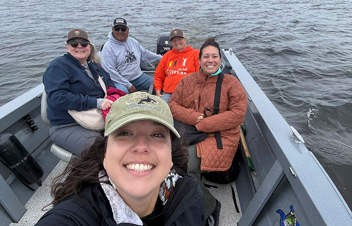 People in a small boat out on the water during Canadian Friends Service Committee's staff visit to Eeyou Istchee